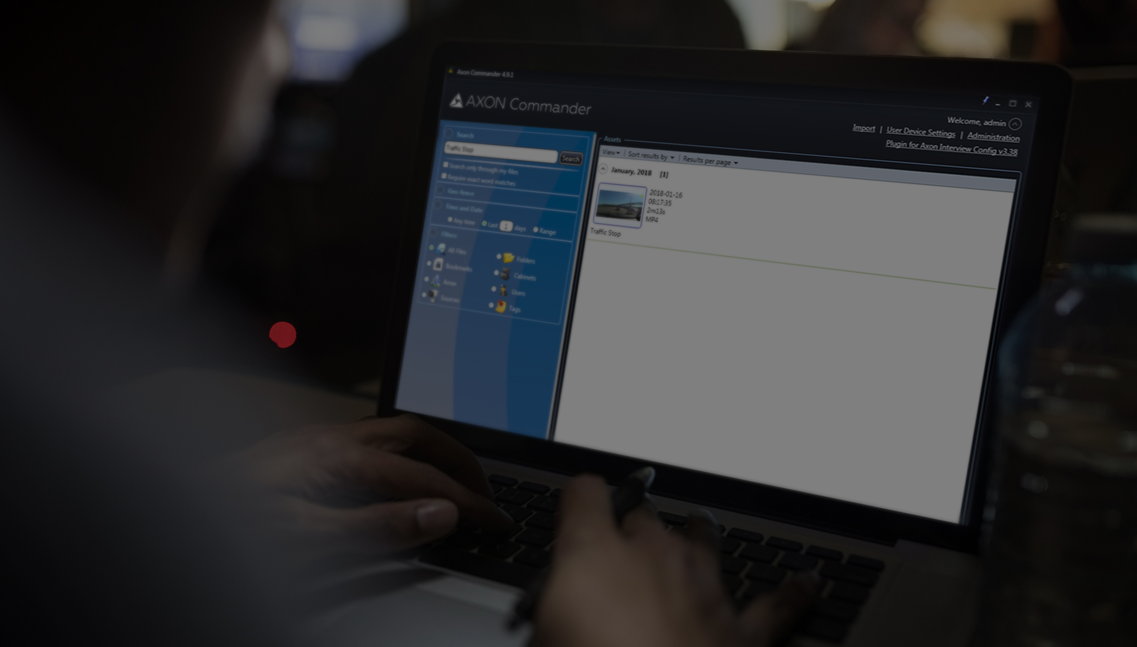 A picture of a person working with AXON Commander from their laptop computer.